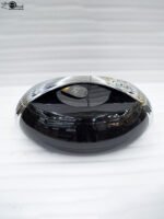 Modern sleek black insulated thermal hotpot casserole with metallic chrome accents on a kitchen counter with fresh hotpot ingredients
