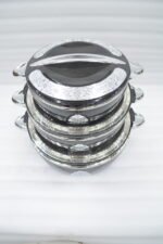 Stacked 3-piece black insulated hot pot set with chrome silver accents on a marble kitchen countertop.