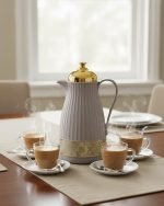 1 Liter luxury vacuum thermos flask with gold top and glass liner, featuring a ribbed body design and push-to-pour button, available in Dark Grey, Grey, and White colors.