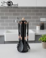 Luxury white marble-look cooking utensil set with rotating holder and rose gold accents. Includes spatula, spoon, and pasta server. Ideal kitchen decor centerpiece.