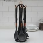 Luxury white marble-look cooking utensil set with rotating holder and rose gold accents. Includes spatula, spoon, and pasta server. Ideal kitchen decor centerpiece.