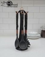 Luxury white marble-look cooking utensil set with rotating holder and rose gold accents. Includes spatula, spoon, and pasta server. Ideal kitchen decor centerpiece.
