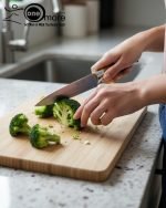 One More luxury 11-piece knife set in rotating stainless steel and clear acrylic block. Features black and gold accented handles, perfect as a modern kitchen centerpiece.