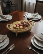 Elevate your home décor and entertaining with this exquisite, ornate gold serving tray. This luxurious decorative metal platter instantly transforms any surface into a dazzling display. Crafted in an opulent Victorian-style with intricate filigree detailing, this piece is the ultimate home accent for those who value timeless glamour.