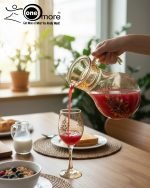 Elegant 7-piece glass water set by One More featuring one amber glass pitcher and six matching goblets, all decorated with a black and gold tulip design.