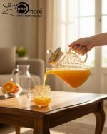 Full 7-piece amber glass water or tea set displayed on a wooden dining table with place mats and six matching cups.