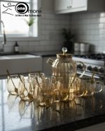 Full 7-piece amber glass water or tea set displayed on a wooden dining table with place mats and six matching cups.