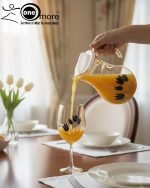 Elegant 7-piece glass water set by One More featuring one amber glass pitcher and six matching goblets, all decorated with a black and gold tulip design.