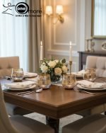 Elegant 7-piece glass beverage set with gold accents including a decanter and six tumblers, shown on a table setting and being used to pour a golden drink.