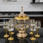 Gold and color-accented honeycomb pattern beverage dispenser and six matching wine glasses set. Available colors include white, teal, emerald green, and navy blue.