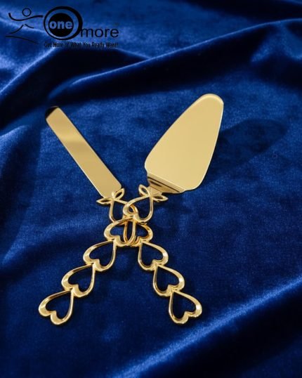 Gold-plated cake knife and server set with ornate handles, shown cutting a white birthday cake, a chocolate wedding cake slice, and displayed on a wooden board with a velvet BG. Elegant serving utensils.