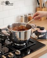 Premium 5-liter stainless steel Turkish pressure cooker with a purple lid and handle, shown cooking meat and vegetables on a stovetop.