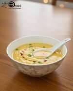 14-piece ceramic soup and ramen bowl set in four color variations: light blue, warm beige, sunset orange, and deep violet marble patterns, all including ceramic spoons and a large serving bowl.