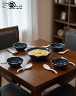 Elegant 14-piece ceramic soup set in six available colors (Black, Navy Blue, Taupe, Slate Grey, Dark Green, Mint Green) featuring scalloped gold rims; includes 1 large serving bowl, 6 small soup bowls, 1 serving spoon, and 6 individual soup spoons, displayed on a kitchen countertop.