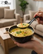 14-piece ceramic soup bowl and spoon set featuring a large serving bowl, six individual bowls, and seven matching spoons, all with a rich color glaze and elegant hand-painted gold rim, available in five colors: black, green, white, taupe, and deep teal.