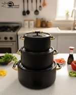 A stacked set of three premium insulated hot pots (1L, 2L, 3.5L) in a crisp white color with decorative gold-toned handles, shown on a marble kitchen countertop. The set features clear acrylic lids and is marketed for keeping food warm.