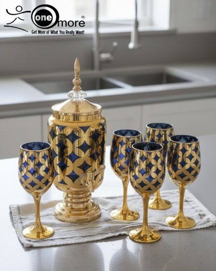 Luxury gold drink dispenser and goblet set with geometric pattern; available in two colors: royal blue/gold and emerald green/gold; featured on a modern kitchen counter.