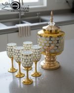 Gold and color-accented honeycomb pattern beverage dispenser and six matching wine glasses set. Available colors include white, teal, emerald green, and navy blue.