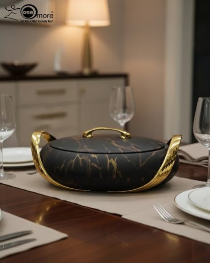 A set of three stacked white marble-patterned insulated casserole dishes (hot pots) with striking gold-tone handles and lids, displayed on a formal dining table.