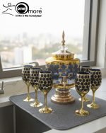 Gold and color-accented honeycomb pattern beverage dispenser and six matching wine glasses set. Available colors include white, teal, emerald green, and navy blue.