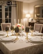 Fancy gold-tone beverage dispenser set with six matching stemmed goblets. The dispenser and glasses have a repeating geometric lattice pattern available in white and gold, blue and gold, or red and gold.