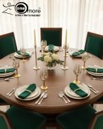 Fancy gold-tone beverage dispenser set with six matching stemmed goblets. The dispenser and glasses have a clear body overlaid with a delicate, scrolling gold floral pattern, and the goblets have solid gold bases.