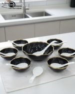 Elegant 14-piece ceramic soup set in six available colors (Black, Navy Blue, Taupe, Slate Grey, Dark Green, Mint Green) featuring scalloped gold rims; includes 1 large serving bowl, 6 small soup bowls, 1 serving spoon, and 6 individual soup spoons, displayed on a kitchen countertop.