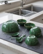 14-piece ceramic soup bowl and spoon set featuring a large serving bowl, six individual bowls, and seven matching spoons, all with a rich color glaze and elegant hand-painted gold rim, available in five colors: black, green, white, taupe, and deep teal.