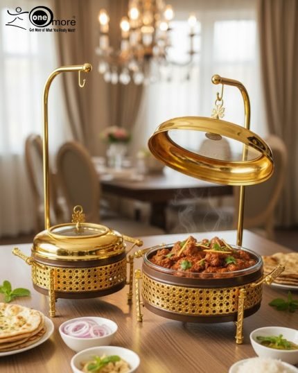 A collection of luxurious gold and deep brown Royal Buffet Server Chafing Dishes, available in 1.5, 2.2, and 3.2-liter sizes. The dishes feature intricate lattice detailing, clear-top lids, and elegant gold stands with hooks for convenient lid placement. The images show the servers beautifully displayed on formal dining and outdoor buffet tables, holding hot dishes like Biryani and curry, emphasizing their elegant design and food-warming capability for weddings and upscale events.
