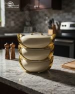 Elegant insulated casserole dish set with gold accents for serving hot food, available in white, sky blue, and blue in 2.5, 3, and 3.5-liter sizes.