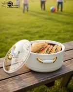 A stacked set of three premium insulated hot pots (1L, 2L, 3.5L) in a crisp white color with decorative gold-toned handles, shown on a marble kitchen countertop. The set features clear acrylic lids and is marketed for keeping food warm.