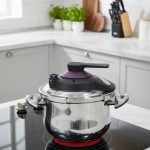 Premium 5-liter stainless steel Turkish pressure cooker with a purple lid and handle, shown cooking meat and vegetables on a stovetop.