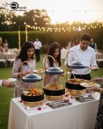 Luxury Royal buffet server set in black and gold color, a 6-liter chafing dish used for serving crispy fried shrimp at a formal dinner table, featuring an elegant golden stand and an overhead lid. The base includes a holder for canned heat or a buffet burner.