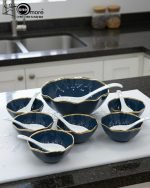 Elegant 14-piece ceramic soup set in six available colors (Black, Navy Blue, Taupe, Slate Grey, Dark Green, Mint Green) featuring scalloped gold rims; includes 1 large serving bowl, 6 small soup bowls, 1 serving spoon, and 6 individual soup spoons, displayed on a kitchen countertop.