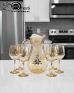 Elegant 7-piece glass water set by One More featuring one amber glass pitcher and six matching goblets, all decorated with a black and gold tulip design.