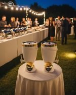 Insulated, stylish beverage dispenser (water cooler) with gold accents on base and spigot, shown in white, green, and chocolate/taupe colors, used for serving drinks on a dining table or kitchen counter.