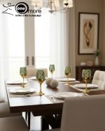 Fancy gold-tone beverage dispenser set with six matching stemmed goblets. The dispenser and glasses have a repeating geometric lattice pattern available in white and gold, blue and gold, or red and gold.