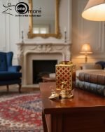 Fancy gold-tone beverage dispenser set with six matching stemmed goblets. The dispenser and glasses have a repeating geometric lattice pattern available in white and gold, blue and gold, or red and gold.