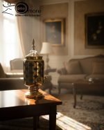 Luxury gold drink dispenser and goblet set with geometric pattern; available in two colors: royal blue/gold and emerald green/gold; featured on a modern kitchen counter.