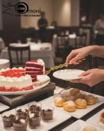 Gold-plated cake knife and server set with ornate handles, shown cutting a white birthday cake, a chocolate wedding cake slice, and displayed on a wooden board with a velvet BG. Elegant serving utensils.