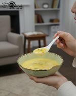 Elegant 14-piece ceramic soup set in six available colors (Black, Navy Blue, Taupe, Slate Grey, Dark Green, Mint Green) featuring scalloped gold rims; includes 1 large serving bowl, 6 small soup bowls, 1 serving spoon, and 6 individual soup spoons, displayed on a kitchen countertop.