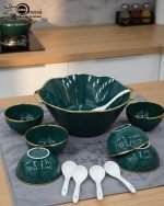 A complete 15-piece ceramic soup set displayed in a kitchen setting, featuring one large scalloped serving bowl, six small individual soup bowls, a golden metal storage stand, and seven white serving spoons. The set is available in six colors: black, dark gray-blue, navy blue, emerald green, beige/nude, and light mint green, all highlighted with an elegant gold rim.