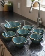 14-piece ceramic soup set in 5 colors (White, Black, Green, Blue, Pink) with gold beaded rim detailing, including one serving bowl, six individual bowls, and seven spoons.