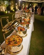 Royal gold and silver chafing dish for buffet service, featuring an ornate laser-cut pattern and a high gold stand with a hinged lid. Available in 4 and 6 liter capacities, designed for catering, weddings, and high-end events to keep foods like biryani, curry, or fried shrimp warm.