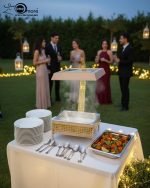 Royal buffet chafing dish set in 4 liter size, featuring a luxurious gold and cream stand, hydraulic lid, and visible canned heat holder (buffet burner) on a dark counter.