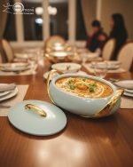 Elegant insulated casserole dish set with gold accents for serving hot food, available in white, sky blue, and blue in 2.5, 3, and 3.5-liter sizes.