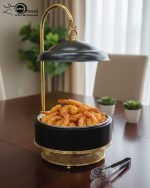 Luxury Royal buffet server set in black and gold color, a 6-liter chafing dish used for serving crispy fried shrimp at a formal dinner table, featuring an elegant golden stand and an overhead lid. The base includes a holder for canned heat or a buffet burner.