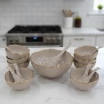 14-piece ceramic soup bowl and spoon set featuring a large serving bowl, six individual bowls, and seven matching spoons, all with a rich color glaze and elegant hand-painted gold rim, available in five colors: black, green, white, taupe, and deep teal.