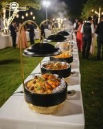 Luxury Royal buffet server set in black and gold color, a 6-liter chafing dish used for serving crispy fried shrimp at a formal dinner table, featuring an elegant golden stand and an overhead lid. The base includes a holder for canned heat or a buffet burner.