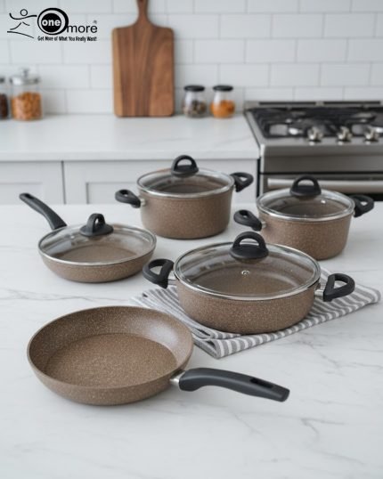 Falez 9-piece brown speckled granite non-stick cookware set displayed on a kitchen counter, featuring a fry pan, shallow casserole, and three deep pots with glass lids - Made in Turkey.